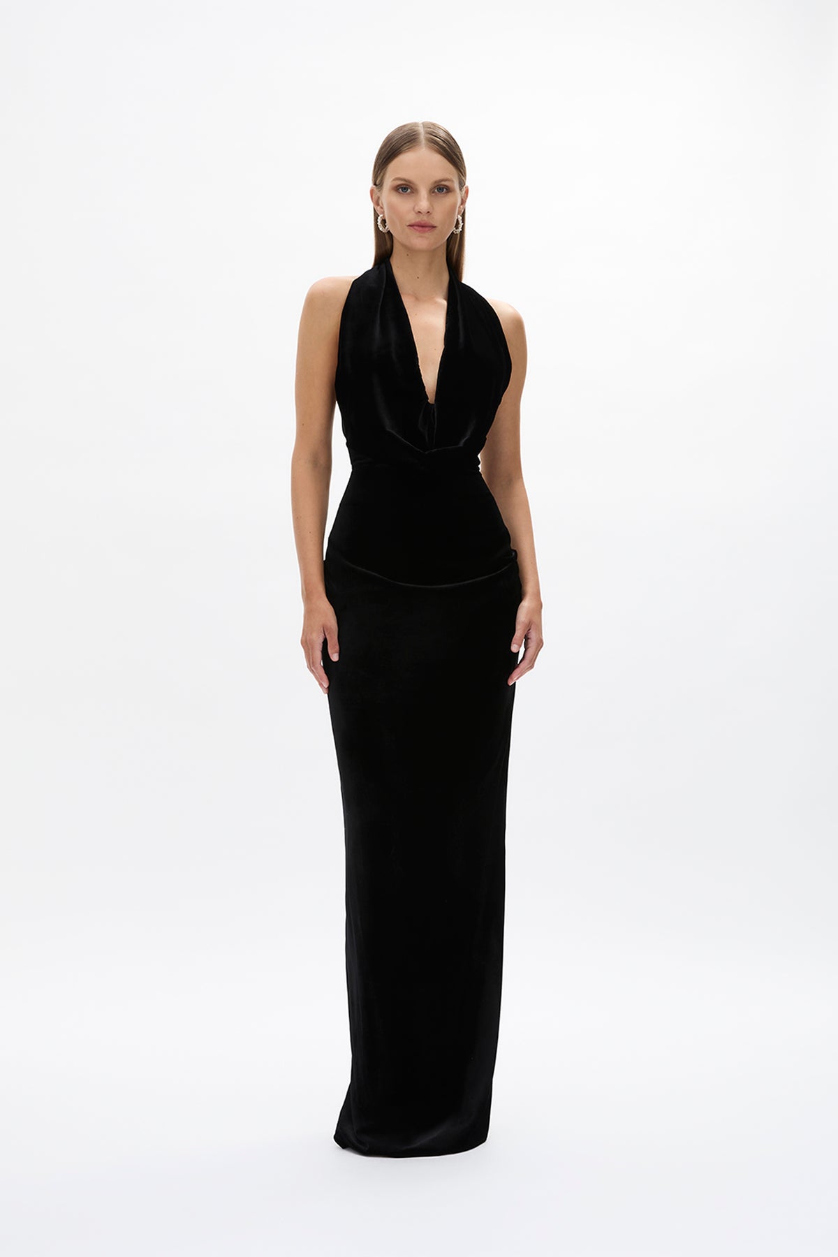 Front image of model wearing Rachel Gilbert Martin Plunge Gown, black velvet halter gown with deep plunge neckline and internal corset.