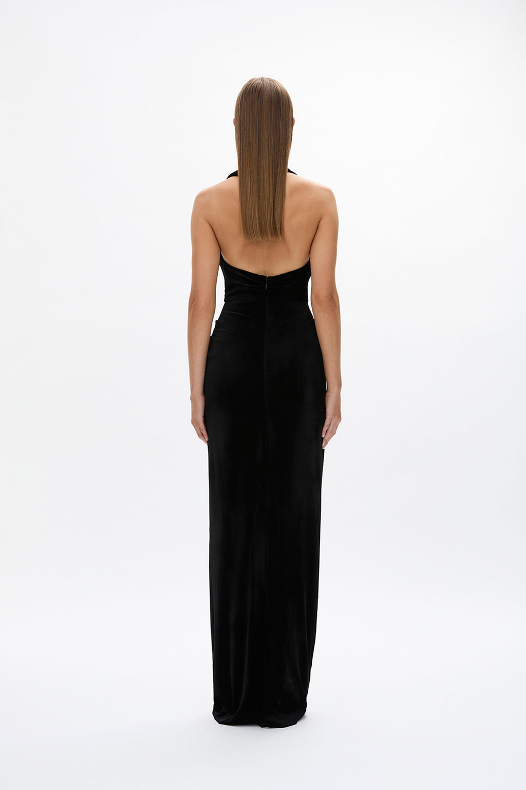 Back image of model wearing Rachel Gilbert Martin Plunge Gown, black velvet halter gown with deep plunge neckline and internal corset.