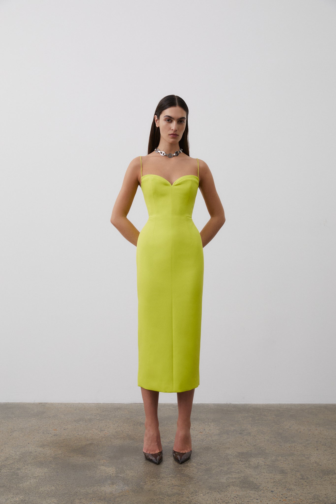 Front on image of model wearing Bodie Dress in Neon featuring sweetheart neckline and thin straps, falling to a mid-length silhouette.