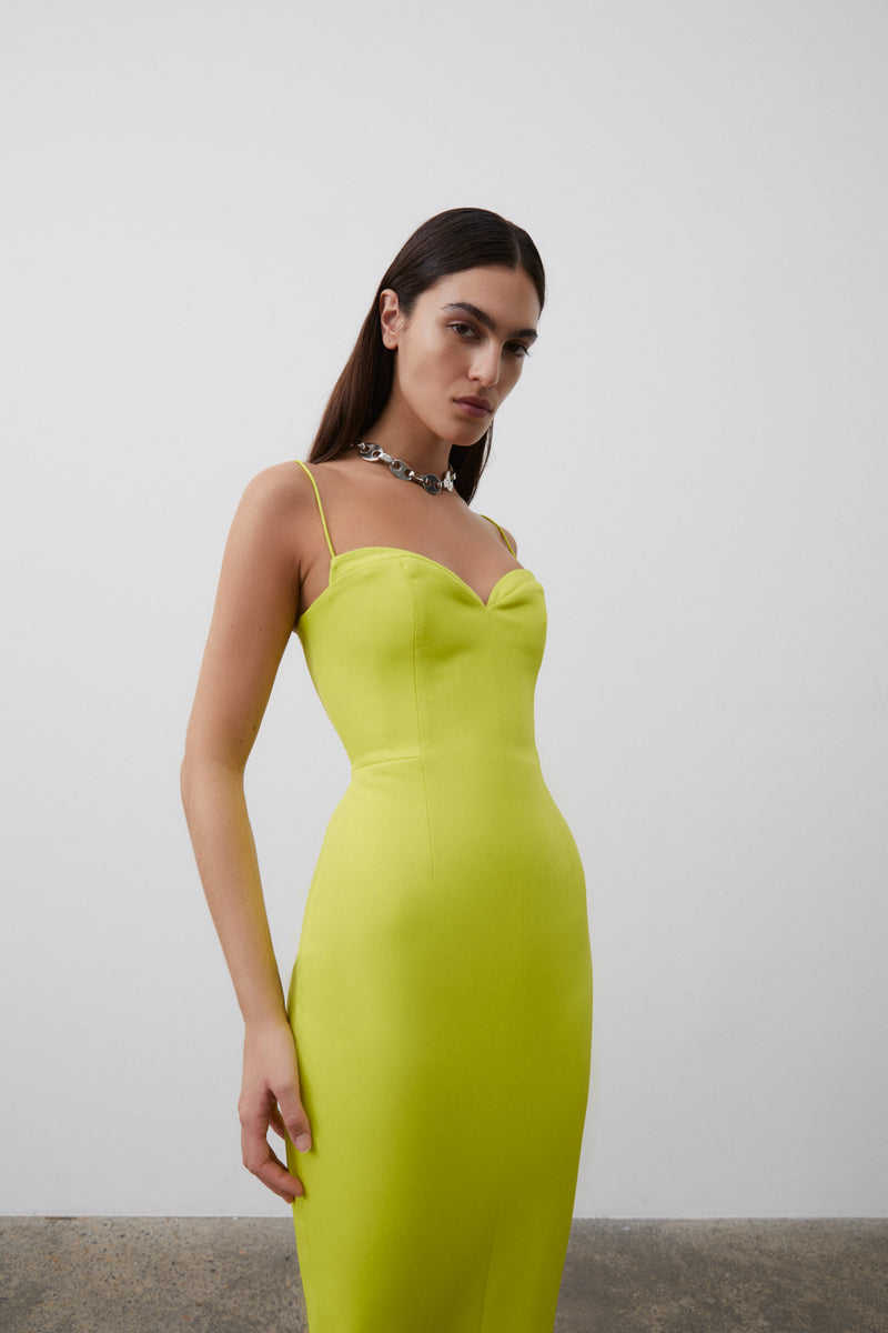 Detail shot of model wearing Bodie Dress in Neon featuring sweetheart neckline and thin straps, falling to a mid-length silhouette.